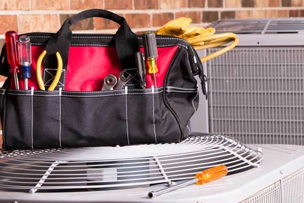 tool bag on top of HVAC unit